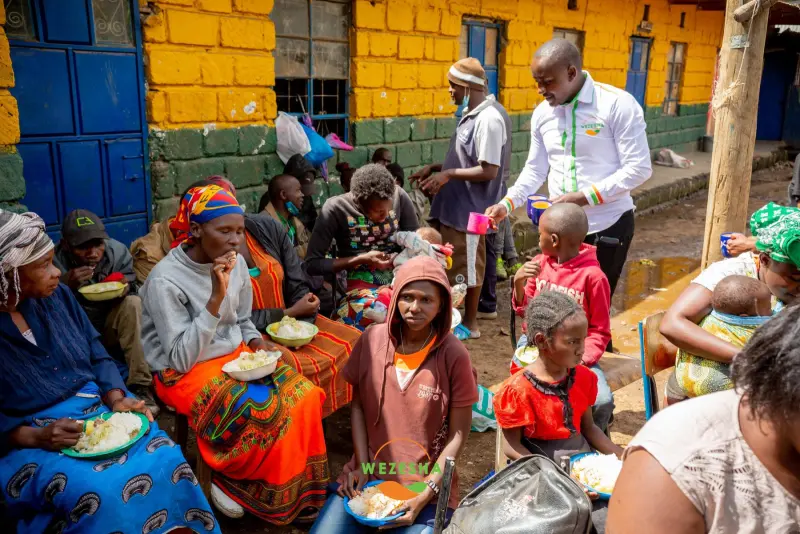 Wezesha Real Estate team serving food to families in Mathare Area 4