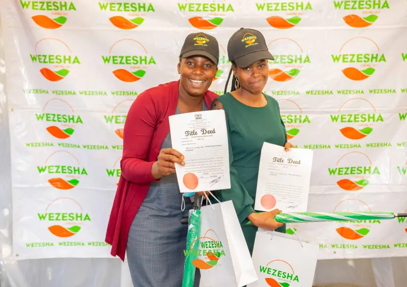 Clients holding their title deeds