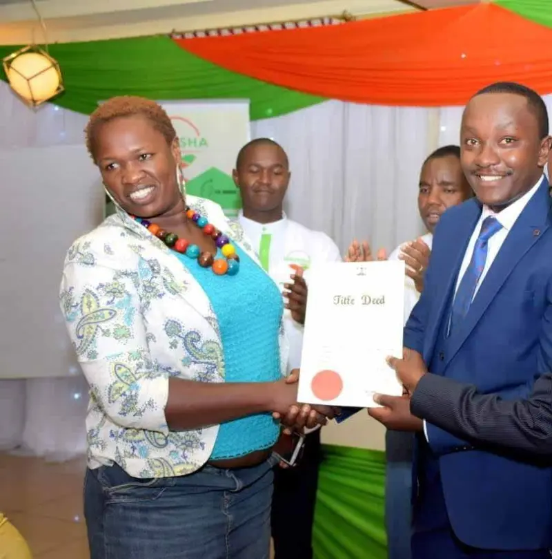 Proud client holding her new title deed